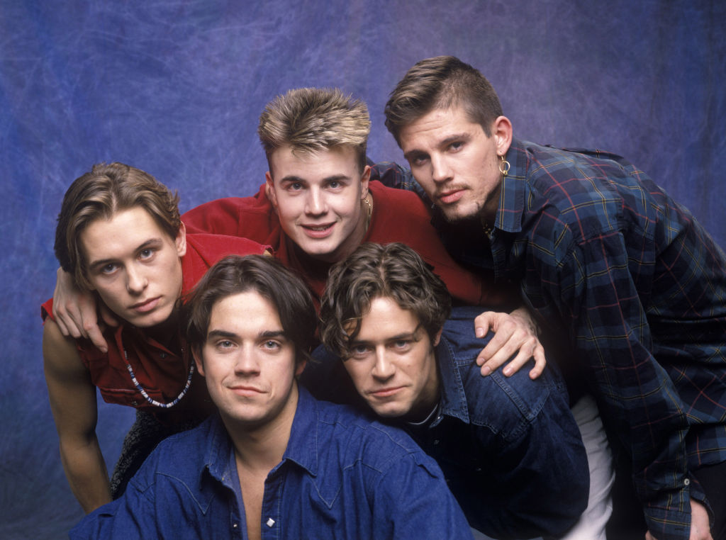 Take That pose for a photo against a blue backgroun in 1993